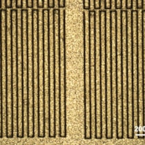 Optical microscope image of an X-ray mask with 10 &mu;m wide asymmetric slits in 130 &mu;m thick gold.