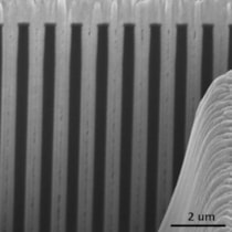 Scanning electron microscopy cross-section image of an array of 650 nm wide and 14 &mu;m deep trenches in silicon uniformly filled with gold by electroplating.